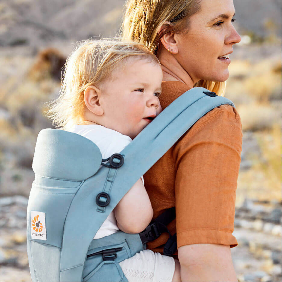 mother carrying child in baby carrier Omni dream